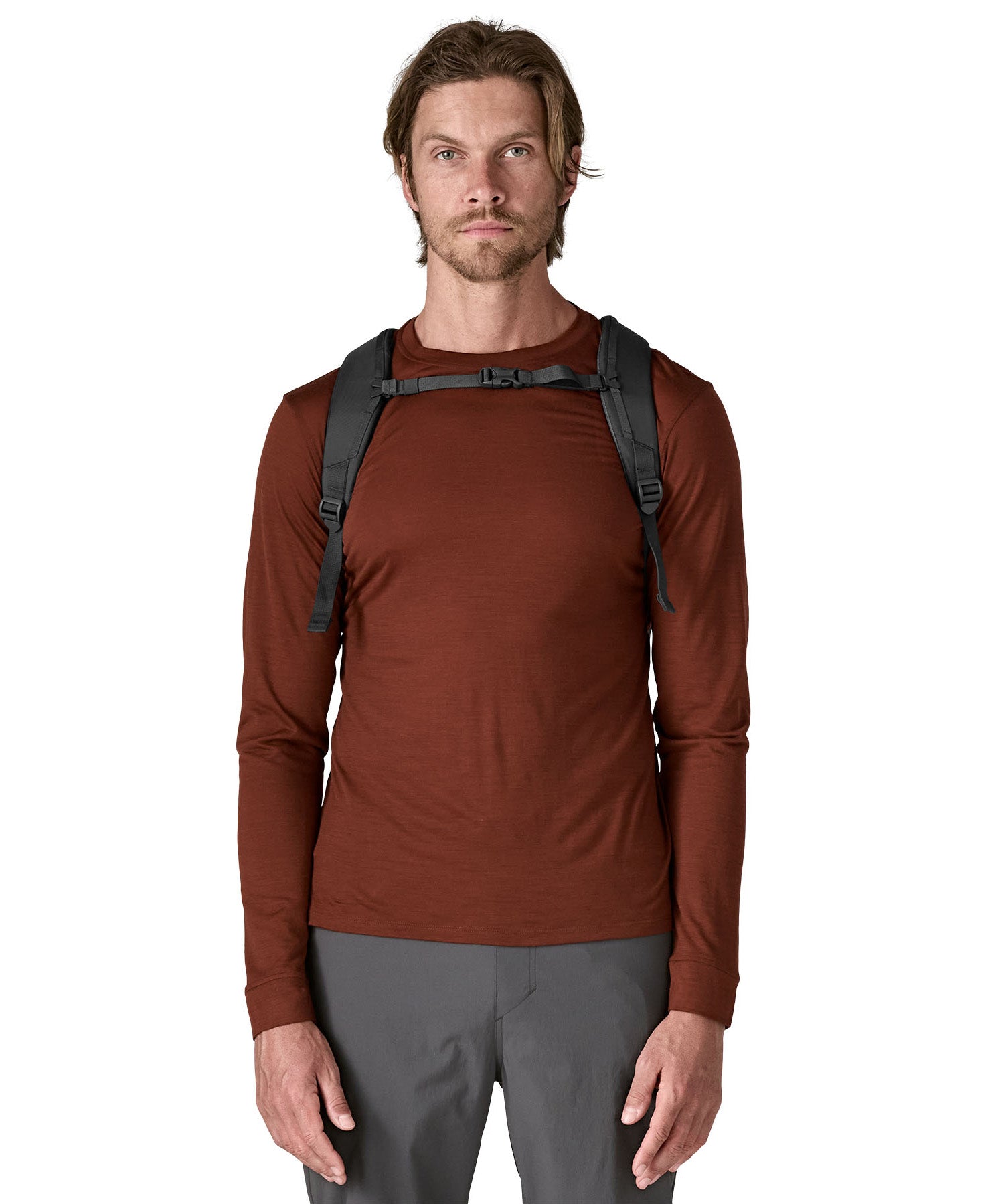  A man wearing the Patagonia smolder  blue 24L atom day pack available at Babipur.