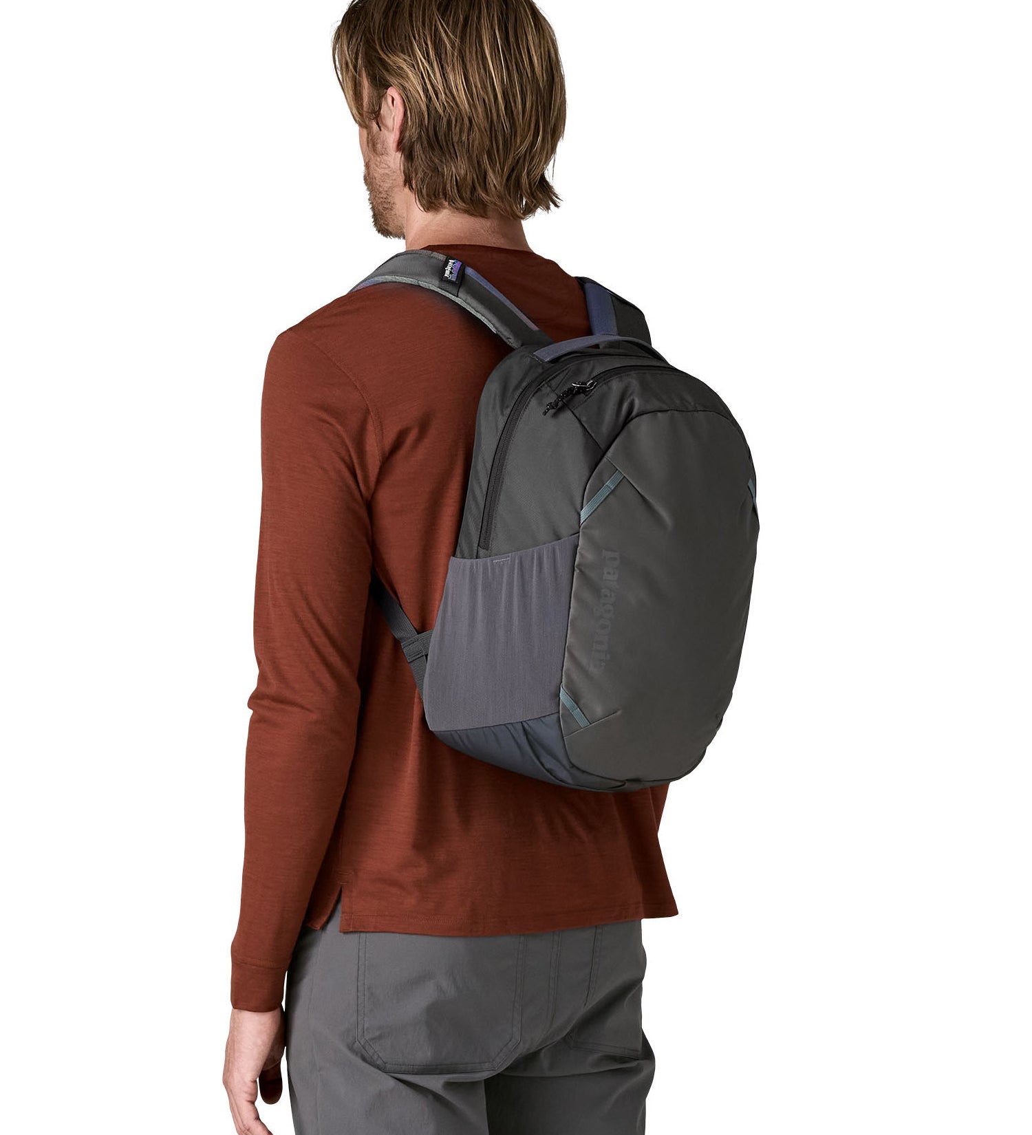 Back of man wearing the Patagonia's smolder blue 24L atom day pack 