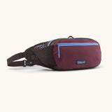 Patagonia terravia hip bag in dark purple with lilac trim. Features 2 zipped compartments and small mesh side pocket