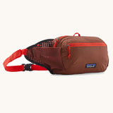 Patagonia terravia 5 litre hip pack. A 100% recycled material hip pack in deep red with bright red detail. Features 2 main compartments, mesh side pockets and a buckle fastener
