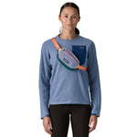A woman wearing the Patagonia terravia mini bum bag in barnacle blue over the shoulder available at Babipur