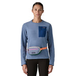 A woman wearing the Patagonia terravia mini bum bag in barnacle blue available at Babipur around the waist showing the zipped compartment on the front panel
