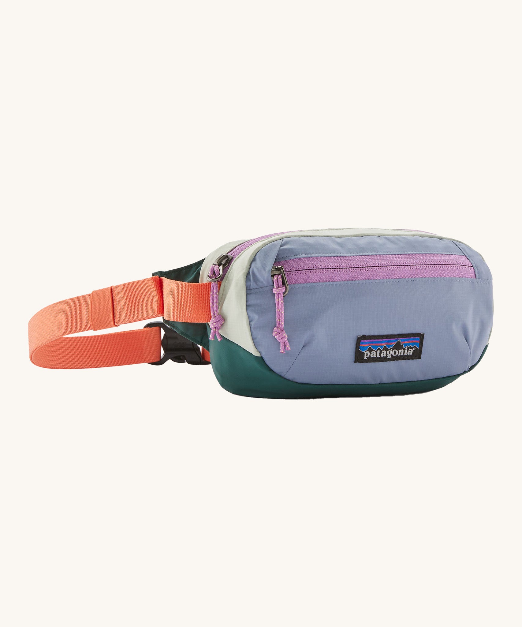 Patagonia terravia mini bum bag in patchwork/barnacle blue available at Babipur. A 100%  recycled material pack in blue and dark green with pink detail. Features 2 main zipped compartments and a buckle fastener on a orange strap