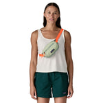 A woman wearing the Patagonia terravia mini bum bag in lichen green over the shoulder available at Babipur