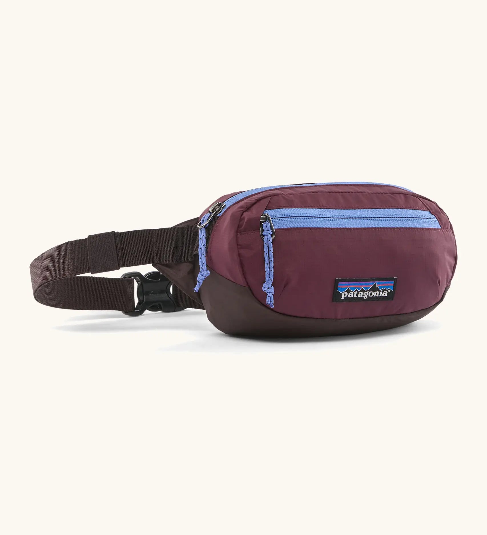 Patagonia 100% recycled nylon weather resistant terravia mini hip pack in maroon. Features 2 compartments with lilac zip detail