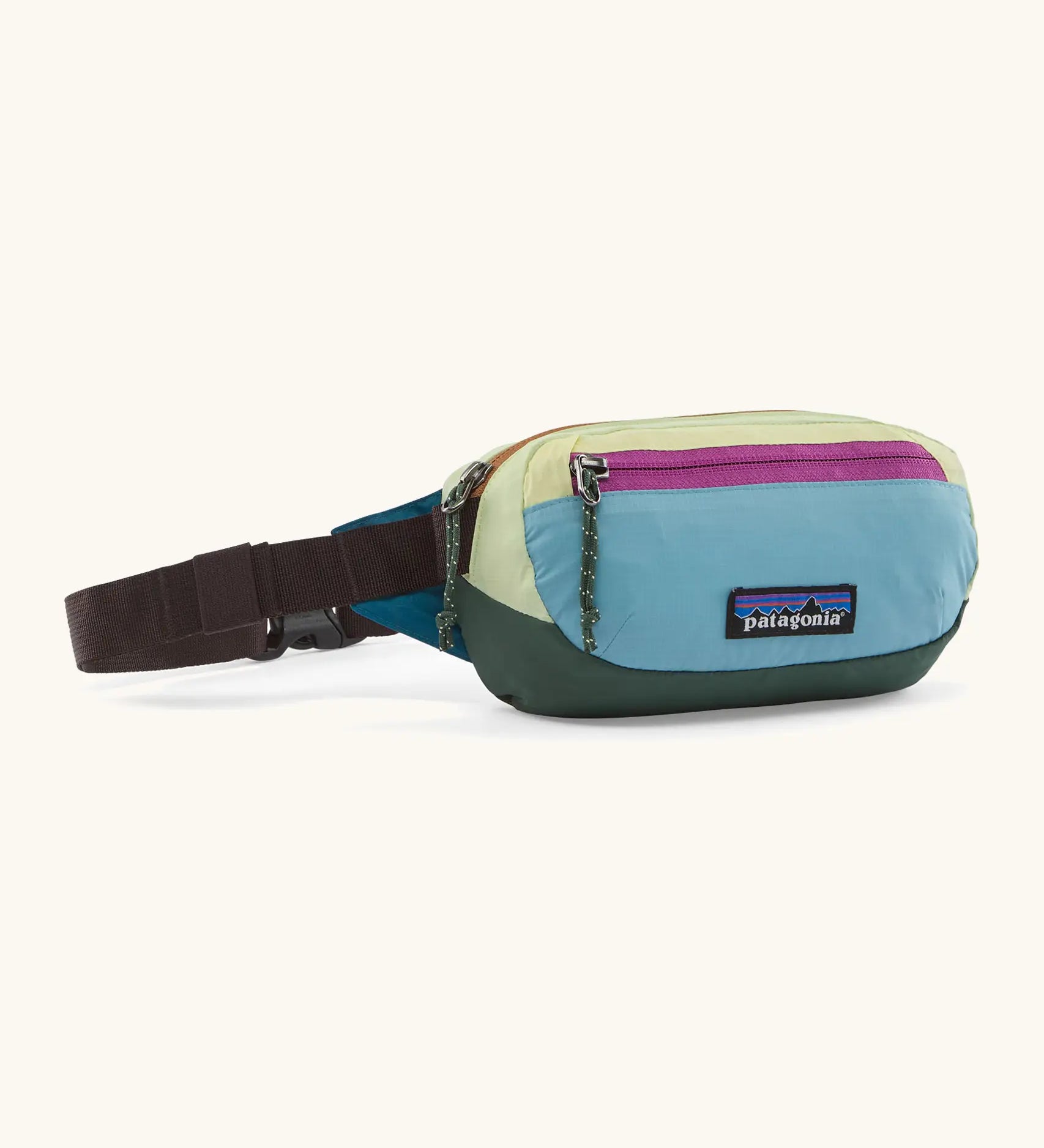 Patagonia 100% recycled nylon weather resistant terravia mini hip pack with blue, pale yellow, and dark green panels, pink zips, and brown straps