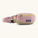 Patagonia recycled nylon terravia mini hip pack in pale pink with green bottom panel. Shows 2 zipped front pockets