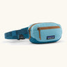 Patagonia 100% recycled nylon weather resistant terravia mini hip pack in bright blue. Features 2 compartments with orange zip detail