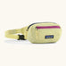Patagonia 100% recycled nylon weather resistant terravia mini hip pack in pale yellow. Features 2 compartments with navy and pink zip detail