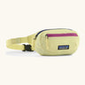 Patagonia 100% recycled nylon weather resistant terravia mini hip pack in pale yellow. Features 2 compartments with navy and pink zip detail