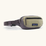 Patagonia 100% recycled nylon weather resistant terravia mini hip pack in grey with beige front panel. Features 2 compartments with black zip detail