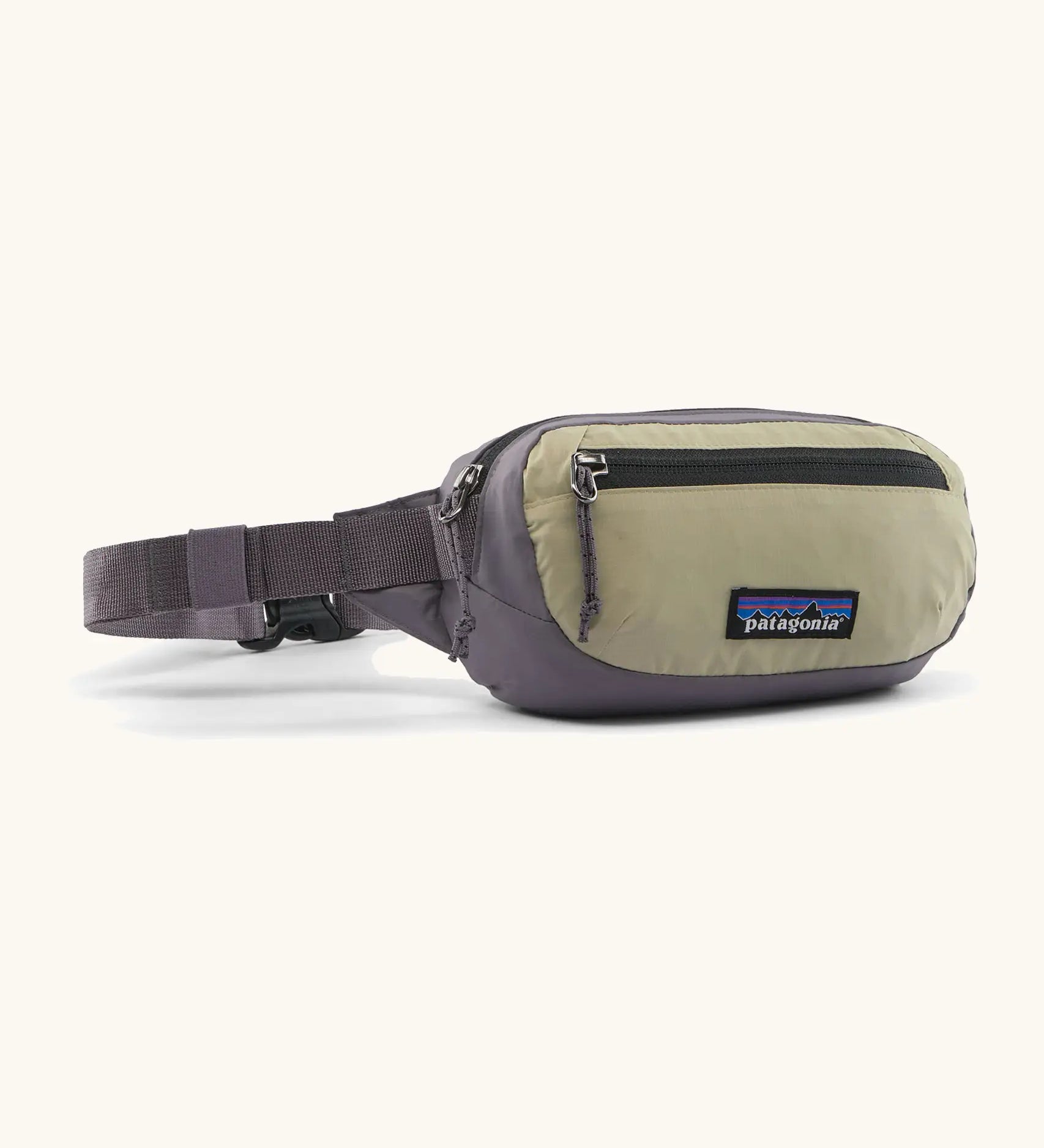 Patagonia 100% recycled nylon weather resistant terravia mini hip pack in grey with beige front panel. Features 2 compartments with black zip detail