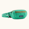 Patagonia water repellent terravia mini hip pack in bright green. Shows 2 zipped front pockets.