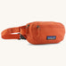 Patagonia terravia mini hip pack in orange made from recycled nylon and weather repellent. Shows 2 zipped front pockets