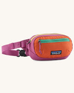 Patagonia weather repellent terravia mini hip pack in pink with orange front . Shows 2 zipped front pockets