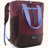 Patagonia water repellent Terravia tote bag in berry with lilac trim. Features a front zip pocket, carry handle, side pockets and shoulder straps 