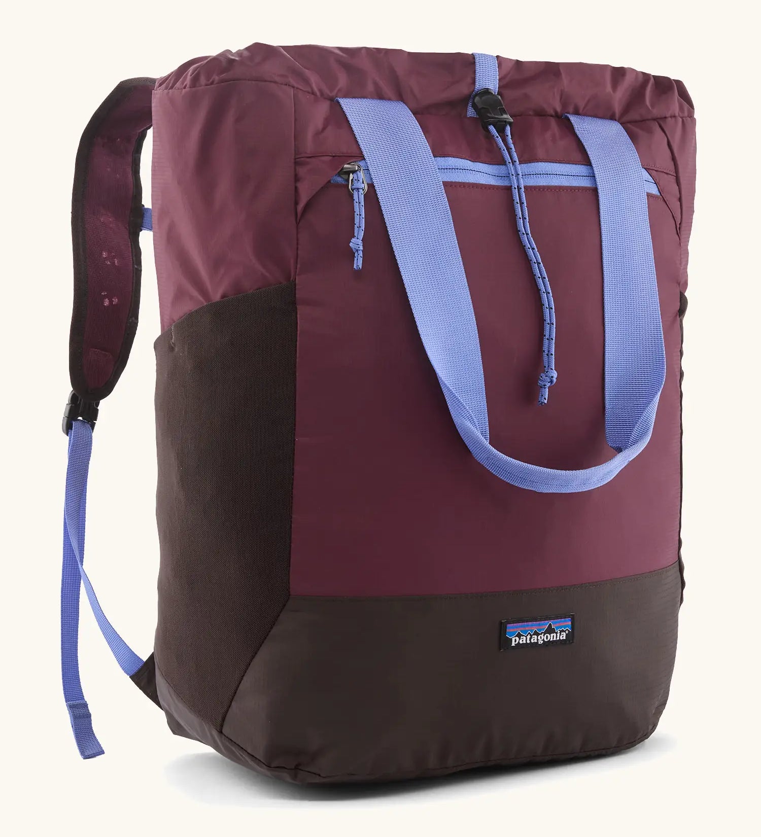 Patagonia water repellent Terravia tote bag in berry with lilac trim. Features a front zip pocket, carry handle, side pockets and shoulder straps 