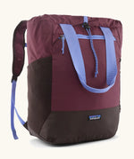 Patagonia water repellent Terravia tote bag in berry with lilac trim. Features a front zip pocket, carry handle, side pockets and shoulder straps 