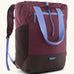 Patagonia water repellent Terravia tote bag in berry with lilac trim. Features a front zip pocket, carry handle, side pockets and shoulder straps 