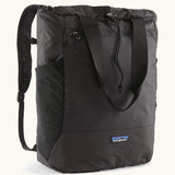 Patagonia water repellent Terravia tote bag in black. Features a front zip pocket, carry handle, side pockets and shoulder straps 