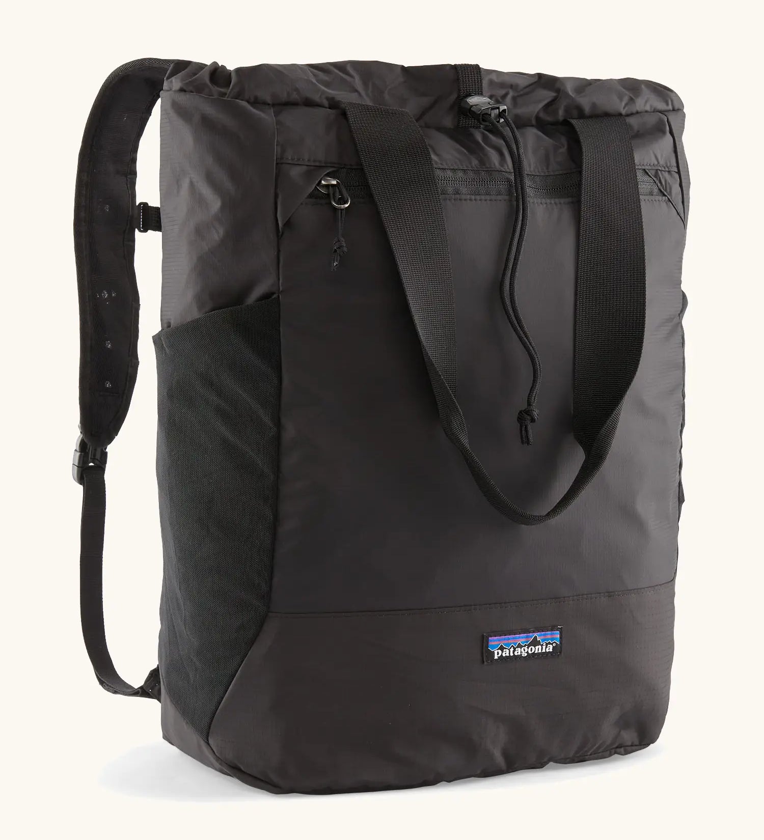 Patagonia water repellent Terravia tote bag in black. Features a front zip pocket, carry handle, side pockets and shoulder straps 