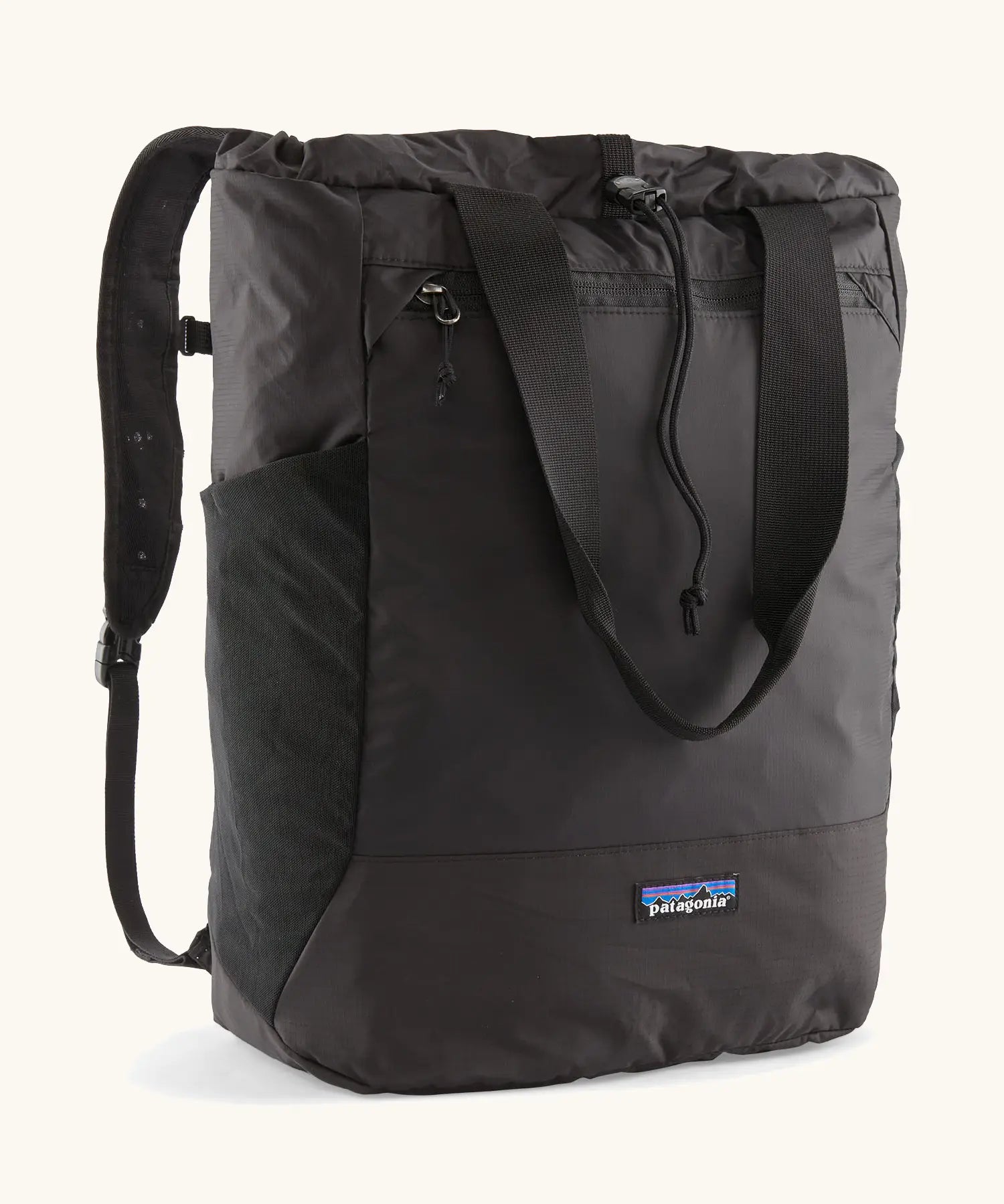 Patagonia water repellent Terravia tote bag in black. Features a front zip pocket, carry handle, side pockets and shoulder straps 
