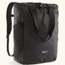 Patagonia water repellent Terravia tote bag in black. Features a front zip pocket, carry handle, side pockets and shoulder straps 