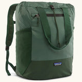 Patagonia water repellent Terravia tote bag in green. Features a front zip pocket, carry handle, side pockets and shoulder straps 