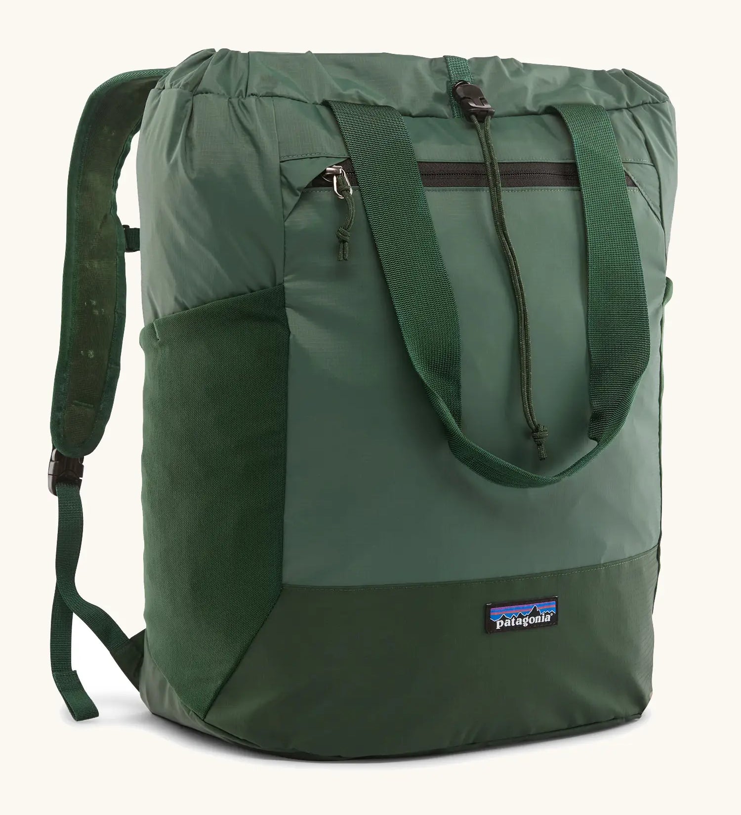 Patagonia water repellent Terravia tote bag in green. Features a front zip pocket, carry handle, side pockets and shoulder straps 