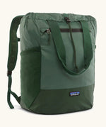 Patagonia water repellent Terravia tote bag in green. Features a front zip pocket, carry handle, side pockets and shoulder straps 