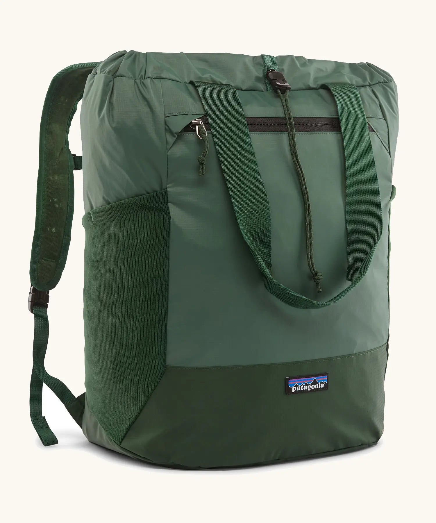Patagonia water repellent Terravia tote bag in green. Features a front zip pocket, carry handle, side pockets and shoulder straps 