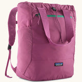 Patagonia terravia tote pack in bright purple with matching carrying handles, straps and a mesh side pocket