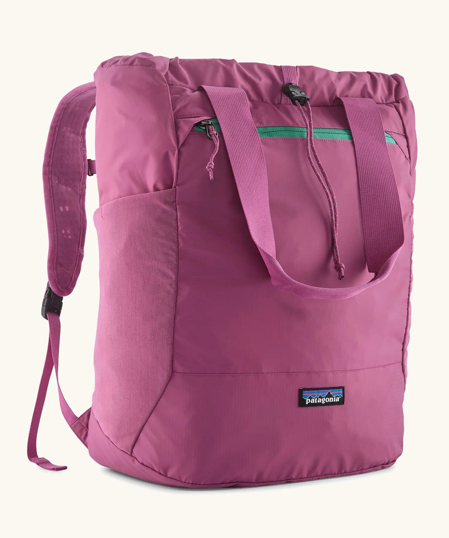 Patagonia terravia tote pack in bright purple with matching carrying handles, straps and a mesh side pocket
