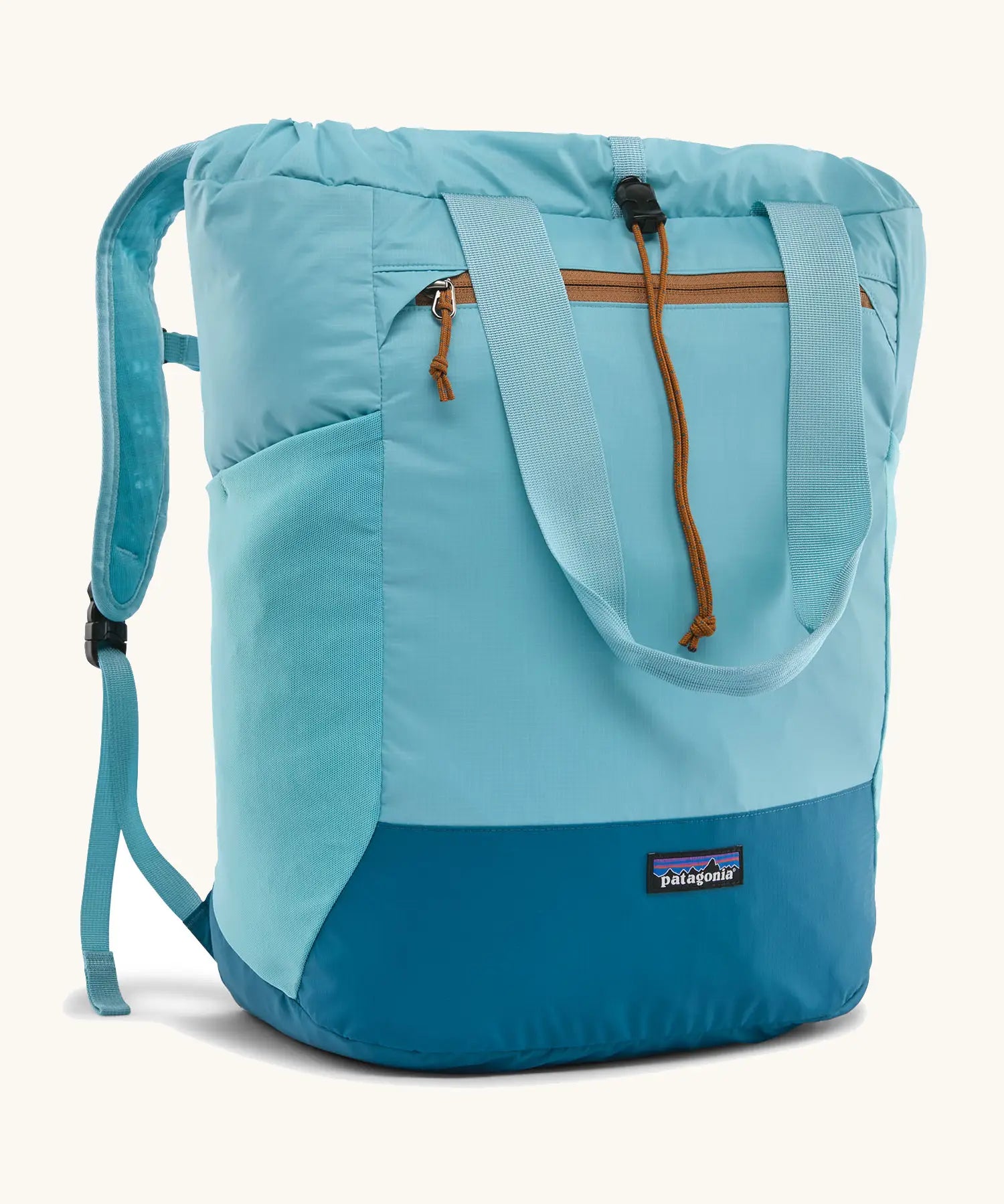 Patagonia water repellent Terravia tote bag in bright blue with a darker blue bottom panel. Features a front zip pocket, carry handle, side pockets and shoulder straps 