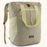 Patagonia water repellent Terravia tote bag in beige with light yellow trim. Features a front zip pocket, carry handle, side pockets and shoulder straps 