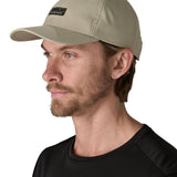 Man wearing Patagonia's recycled fast drying 100% nylon terrebonne cap in light green. Cap has a mid crown design