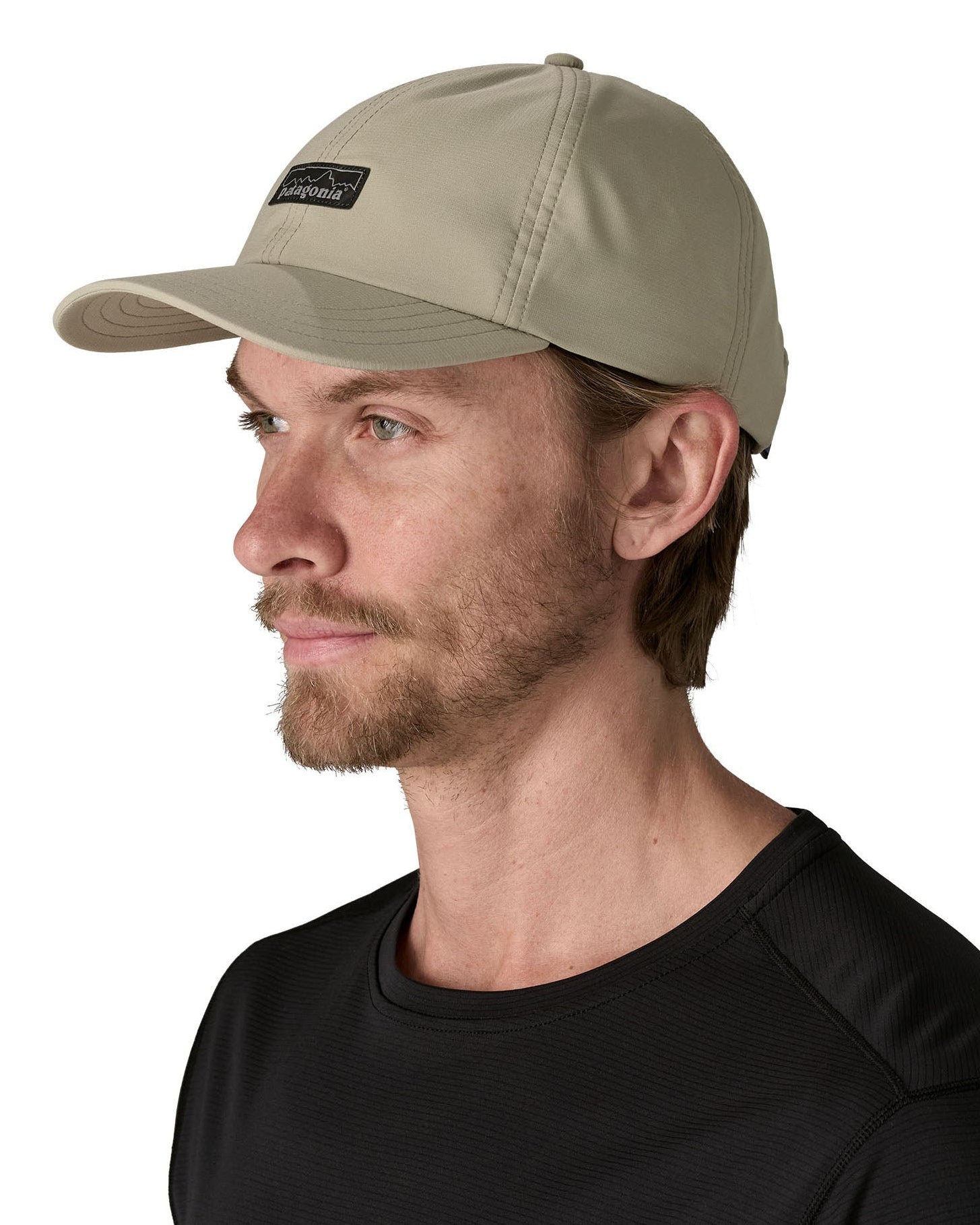 Man wearing Patagonia's recycled fast drying 100% nylon terrebonne cap in light green. Cap has a mid crown design