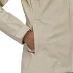 A person is putting their hand in the pocket of the Patagonia Women's Torrentshell 3L Rain Jacket