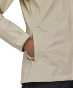 A person is putting their hand in the pocket of the Patagonia Women's Torrentshell 3L Rain Jacket