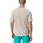 A person wearing light blue shorts, is wearing the Patagonia Men's Cap Cool Trail Graphic T-Shirt to show the fit from the black