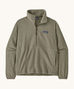 Patagonia women's lightweight fleece in dark green. Features a half length front zip and side pockets