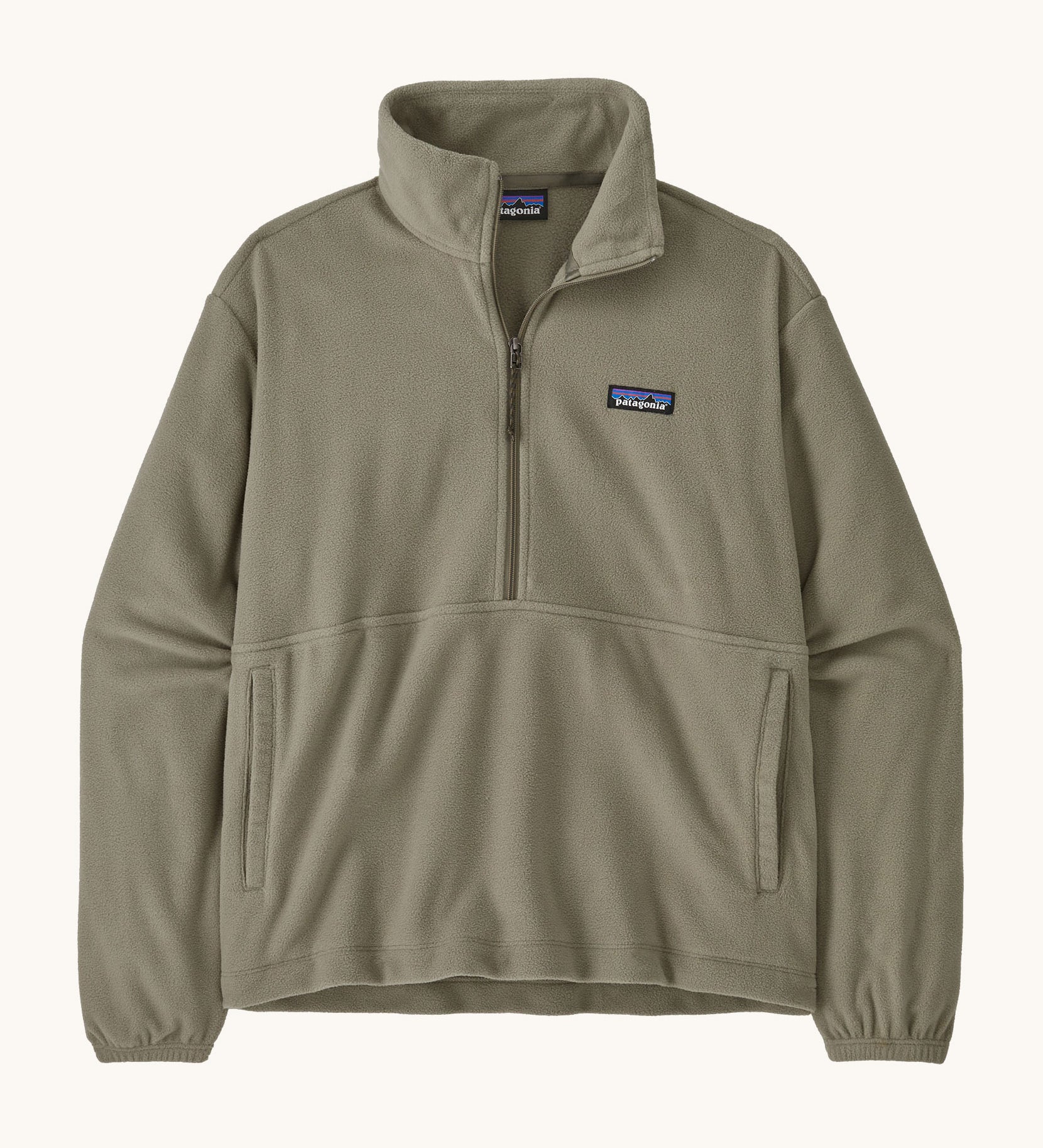 Patagonia women's lightweight fleece in dark green. Features a half length front zip and side pockets