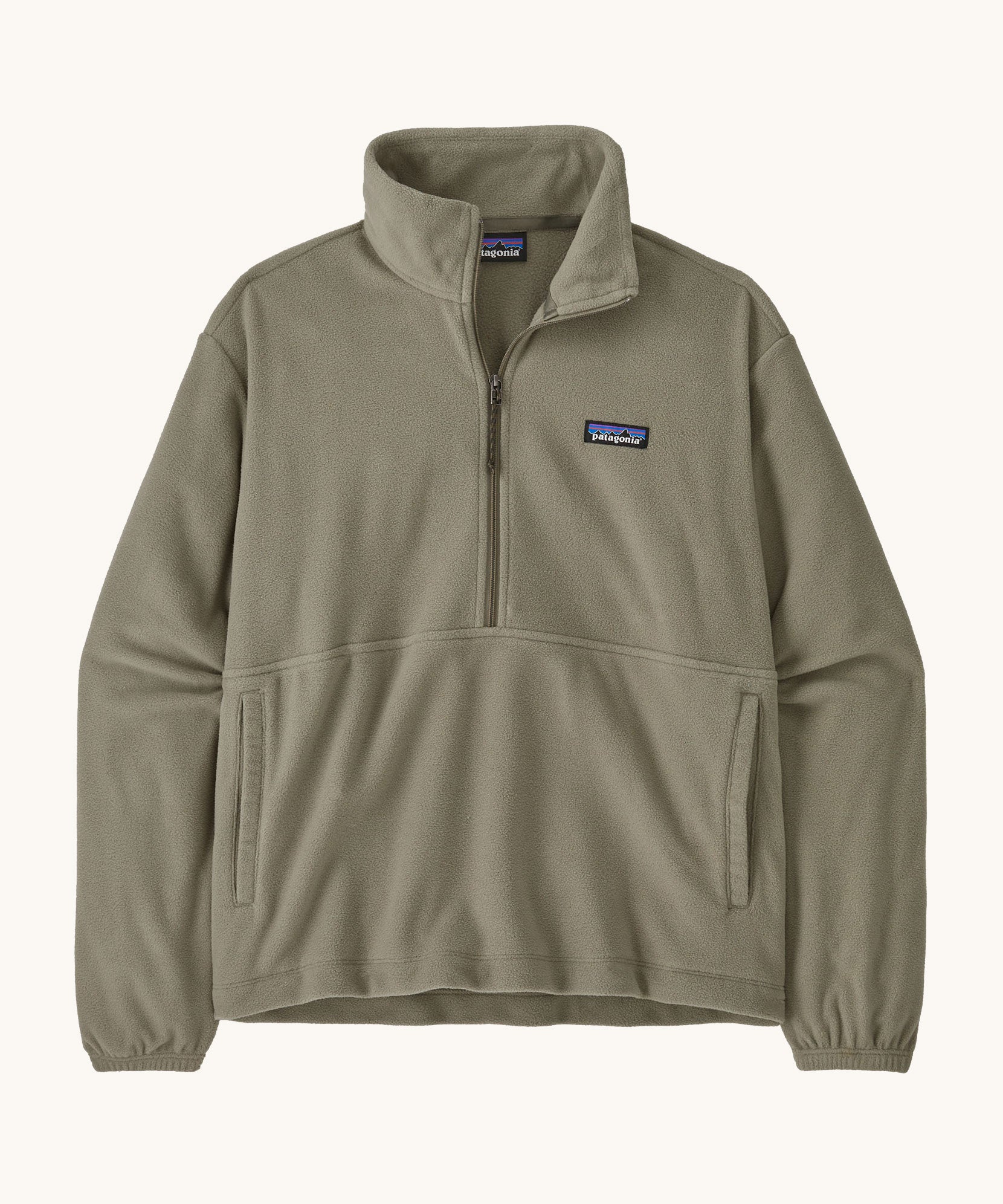 Patagonia women's lightweight fleece in dark green. Features a half length front zip and side pockets