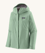Patagonia hooded rain coat in pastel green colour with a grey inner lining. Features a full length front zip and side pockets.