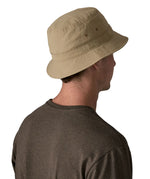 Back of man wearing Patagonia's breathable quick drying wavefarer bucket hat in khaki green with air holes on the side