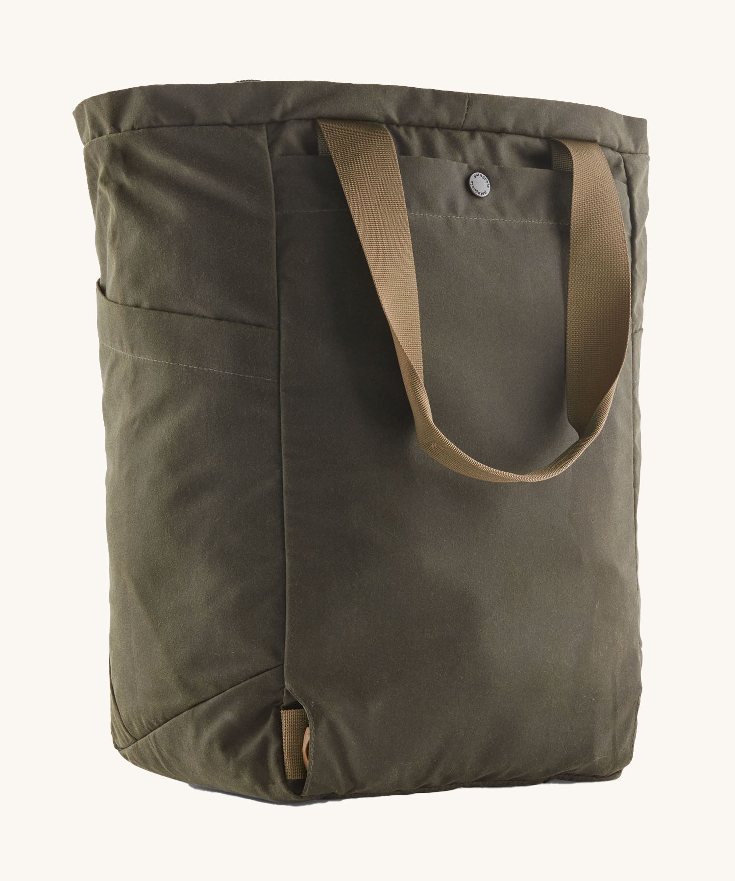 The back of the Patagonia Waxed Canvas Tote Pack Basin Green, showing the carry handle 