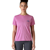 A woman wearing the Patagonia capilene cool daily graphic tshirt in 73 skyline brisk purple available at Babipur. A short sleeve top in bright purple with a brand logo on the left chest. 