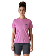 A woman wearing the Patagonia capilene cool daily graphic tshirt in 73 skyline brisk purple available at Babipur. A short sleeve top in bright purple with a brand logo on the left chest. 