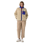 A woman wearing the Patagonia women's classic retro-x jacket in a dark natural colour way available at Babipur.