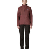 A woman wearing the Patagonia R2 crossstrata jacket in dark ruby available at Babipur. Features a full length zip, 2 side pockets and easy access chest pockets